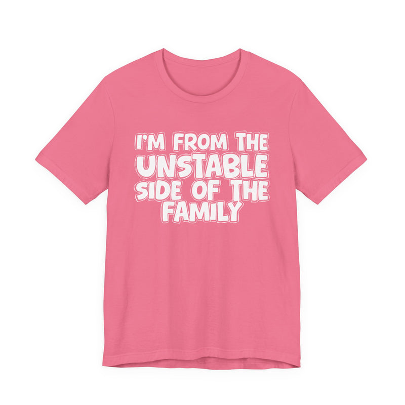 Charity Pink t-shirt with white outlined bubble lettering reading 'I'M FROM THE UNSTABLE SIDE OF THE FAMILY', front flat-lay view.