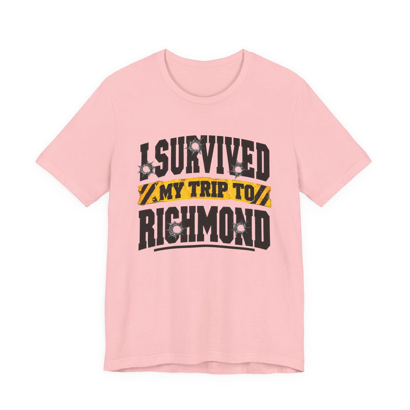 T-Shirt product photo with arched collegiate lettering reading "I SURVIVED" with bullet-hole decals, a caution-tape band reading "MY TRIP TO", and large block letters reading "RICHMOND", front view.